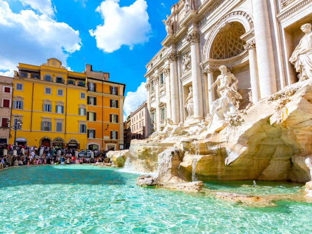 Tourists surrounding the Trevi Fountain in Rome