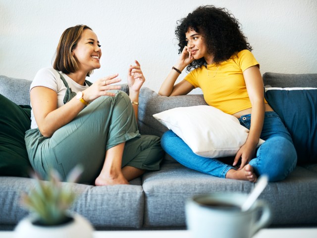 Two women talking on sofa