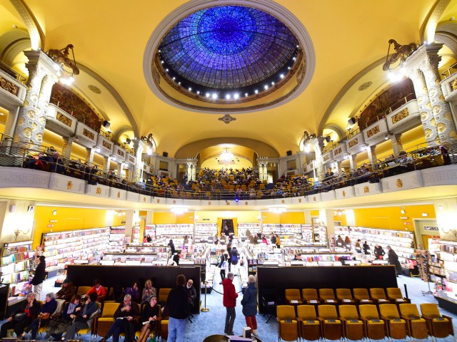 Domed yellow interior of Giunti Odeon Libreria e Cinema in Florence, Italy