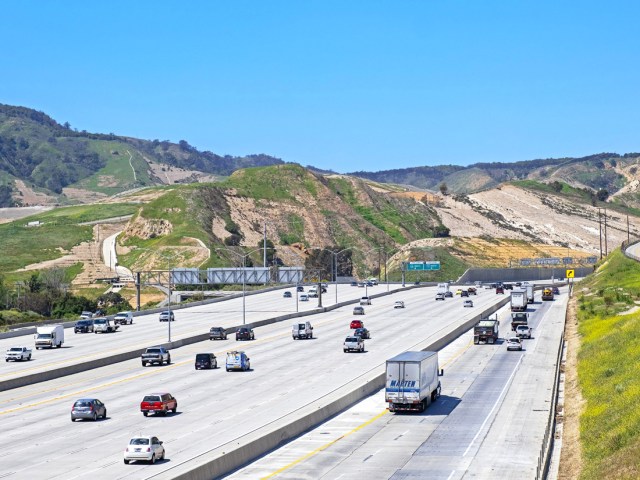 Cars and trucks driving on Interstate 5 through mountains of Southern California