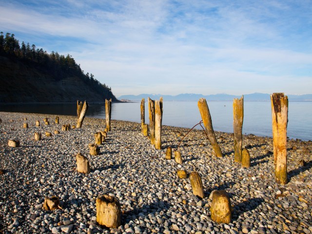 Remains of former salmon cannery on rocky beach in Point Roberts, Washington