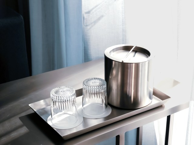 Empty glasses and ice bucket in hotel room