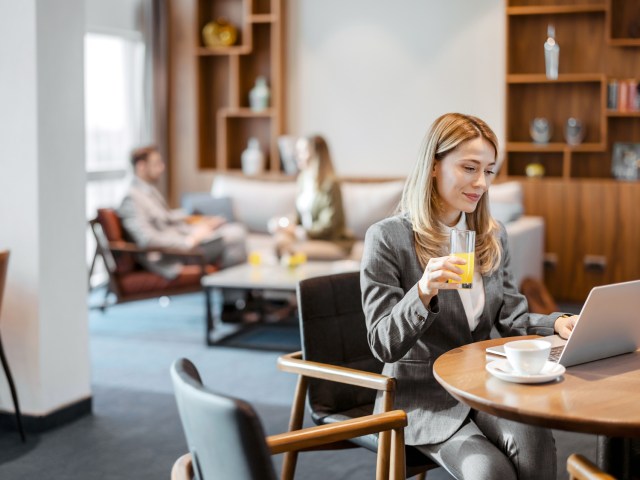 Traveler working on laptop in airline lounge