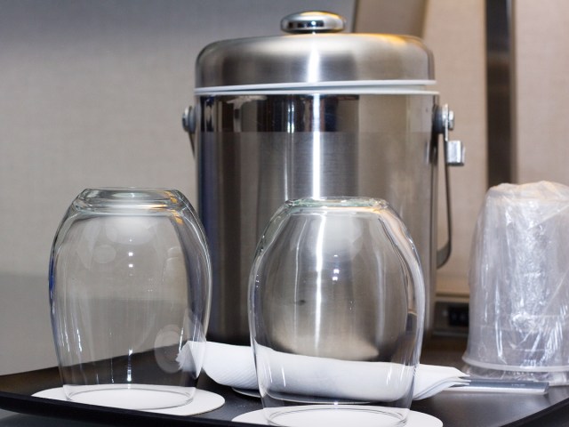 Empty glasses and ice bucket in hotel room