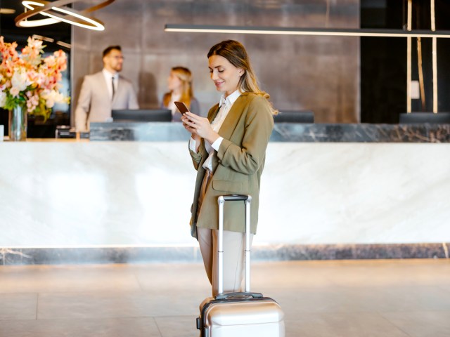 Traveler with suitcase in hotel lobby