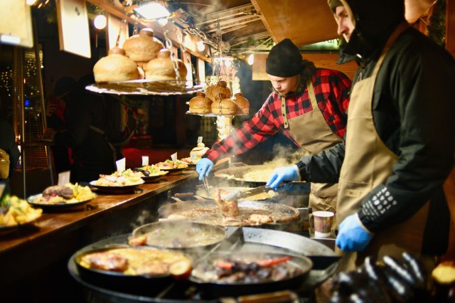 Chefs preparing traditional holiday foods at market in Estonia