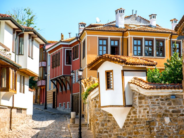 Colorful buildings along cobblestone street in Plovdiv, Bulgaria