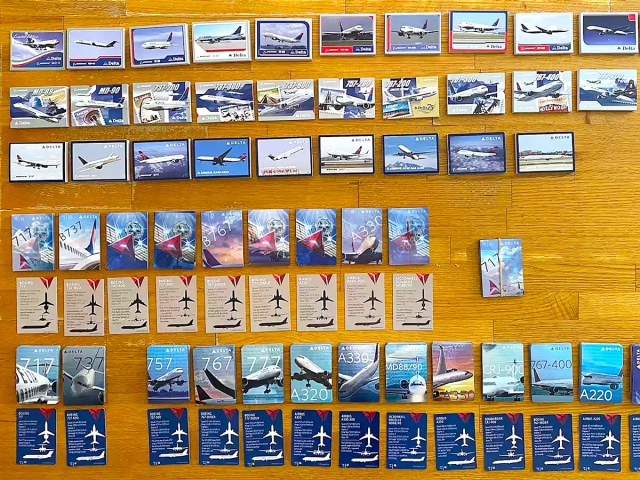 Various Delta Air Lines trading cards laid out on table