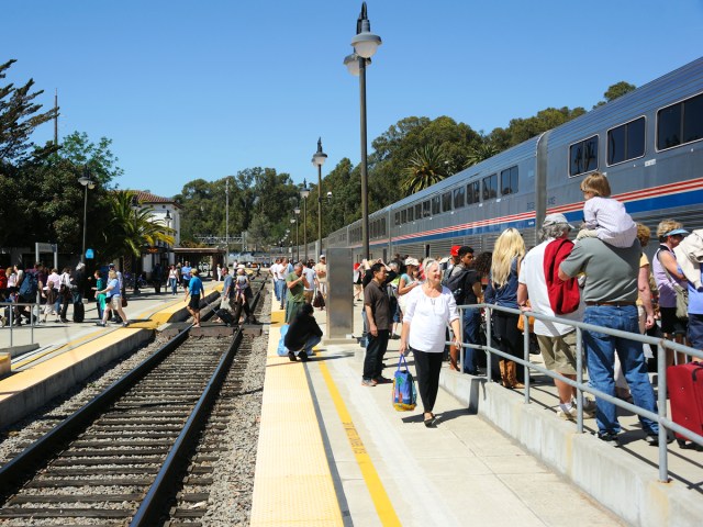 Passengers waiting to board Amtrak train at station