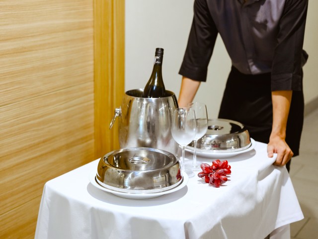 Hotel employee delivering room service