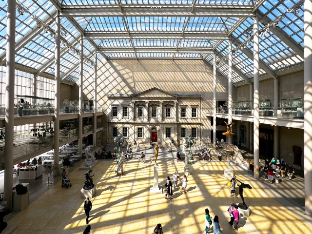 Patrons inside light-filled exhibit hall at the Metropolitan Museum of Art