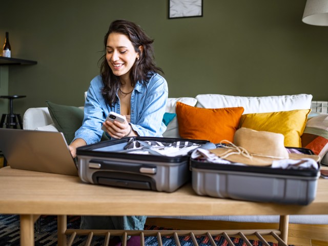 Woman with suitcase and laptop coputer