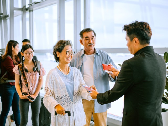 Passengers standing in queue to board plane