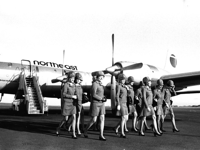 Flight crew walking in front of Northeast Airlines plane