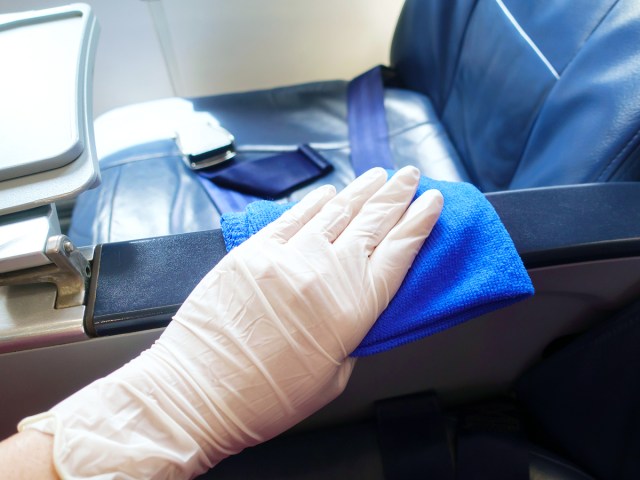 Cleaning crew cleaning aircraft seat