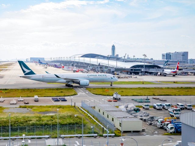 Airplane taxiing past terminal at Osaka Kansai Airport in Japan