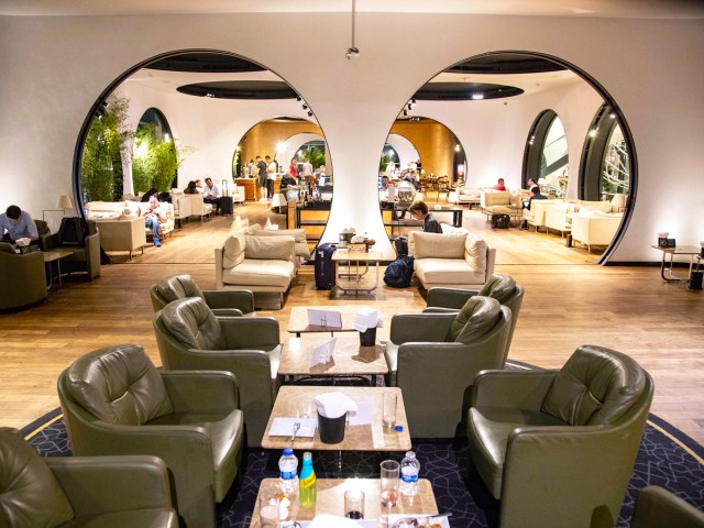 Plush chairs and tables inside airline lounge