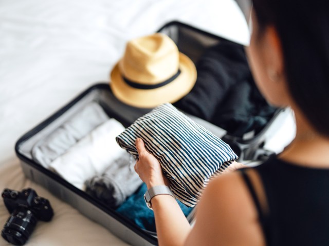 Person packing suitcase