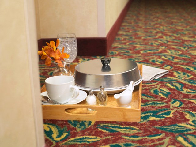 Discarded room service tray in hotel hallway