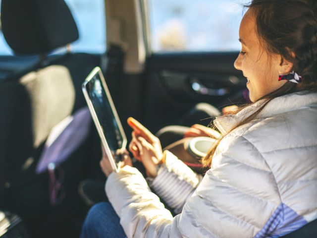 Passengers riding in back seat of car