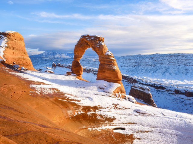 Sandstone arch in Utah's Arches National Park covered with snow