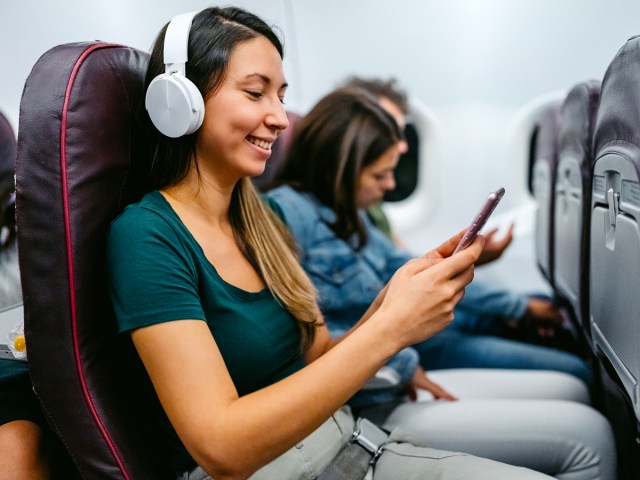 Airline passenger wearing headphones