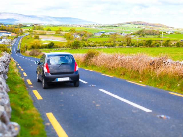 Car driving on rural road in Ireland