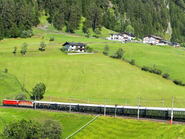 Venice Simplon-Orient-Express passing through quaint mountain village