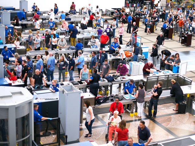 Busy airport security screening area, seen from above