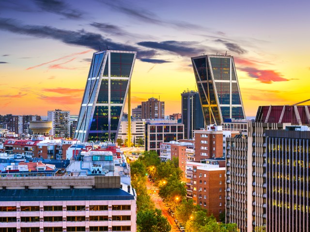 The Gate of Europe towering over skyline of Madrid, Spain, at sunset