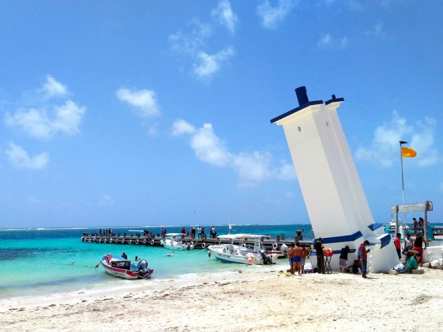 The Leaning Lighthouse on sandy beach in Puerto Morelos, Mexico