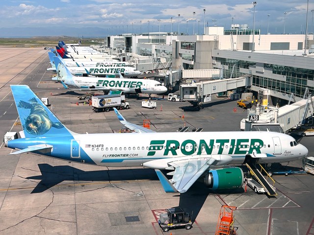 Frontier Airlines aircraft parked at gates at Denver International Airport