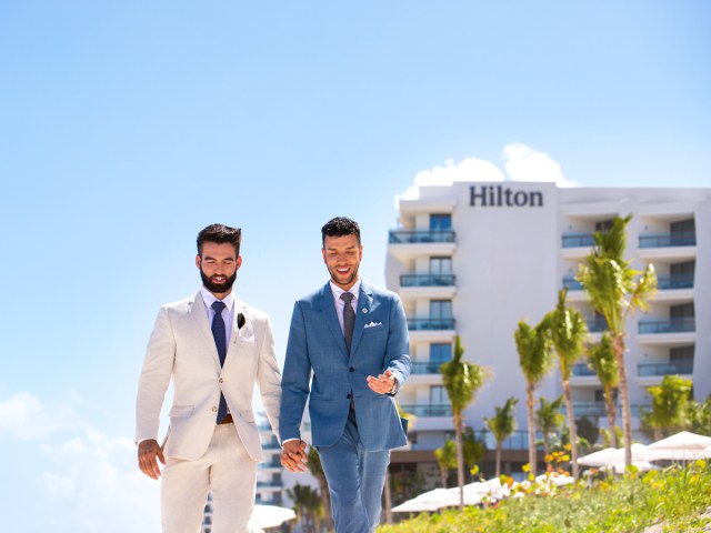 Couple holding hands at Hilton Cancun, An All Inclusive Resort