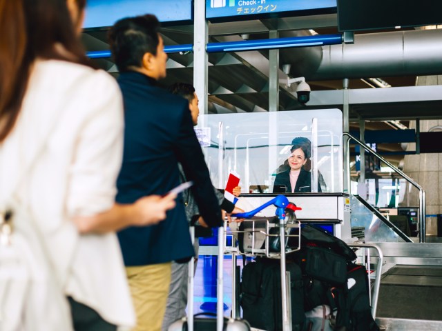 Airline passengers standing in customs line at airport