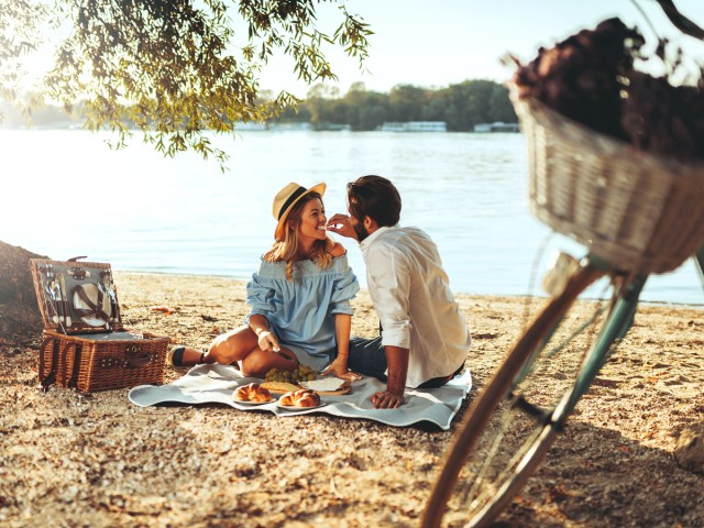 Couple enjoying picnic on beach