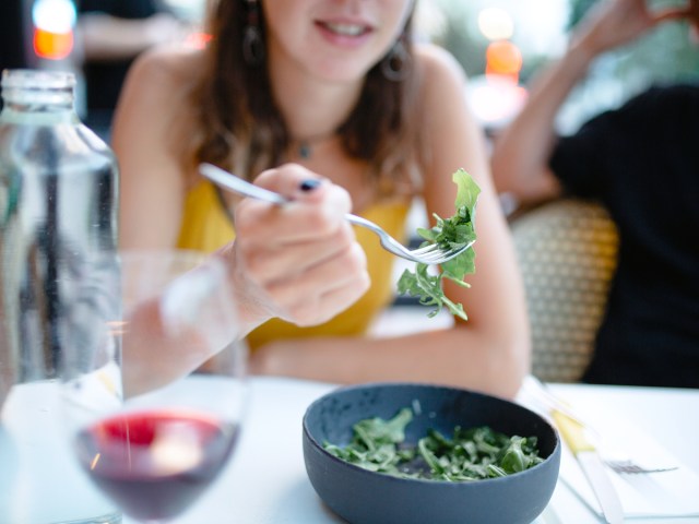 Diner eating arugula salad