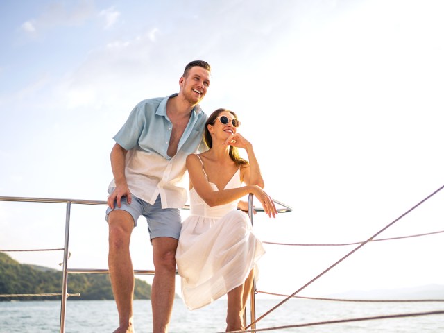 Couple standing on cruise ship overlooking sea