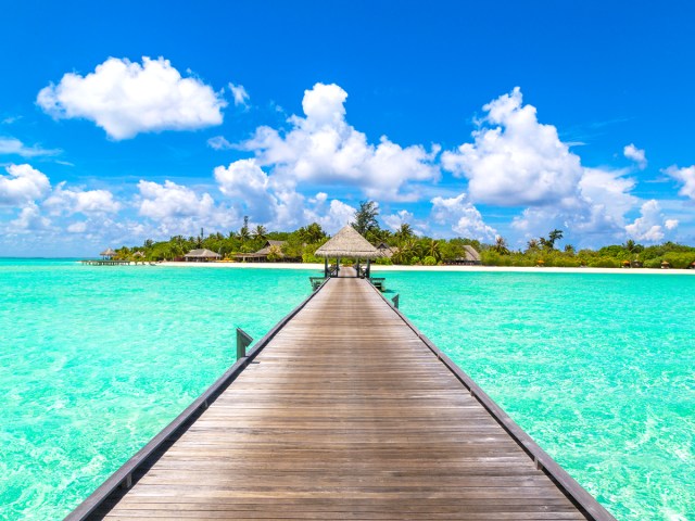 Pier extending out over turquoise water in the Maldives
