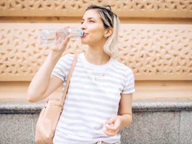 Woman drinking bottle of water