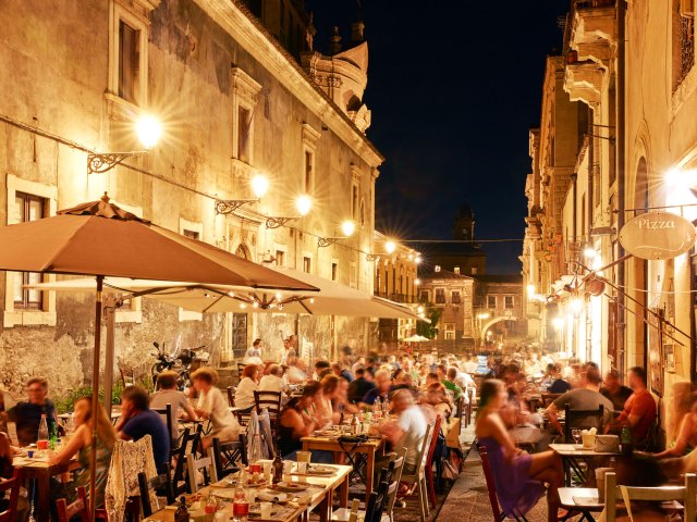 Late-night diners on the streets of Catania, Italy