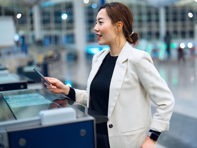 Traveler presenting passport at airport check-in desk