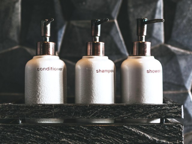 Bottles of conditioner, shampoo, and shower gel