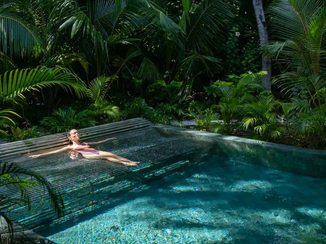 Woman relaxing in pool at Joali Being in the Maldives