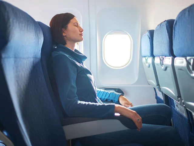 Airline passenger sleeping in seat