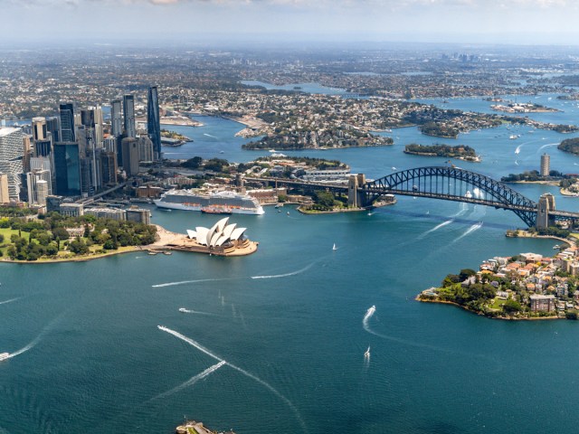 Aerial view of Sydney Harbour today, with bridge and opera house