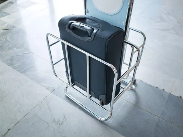 Carry-on bag in metal sizer at airport