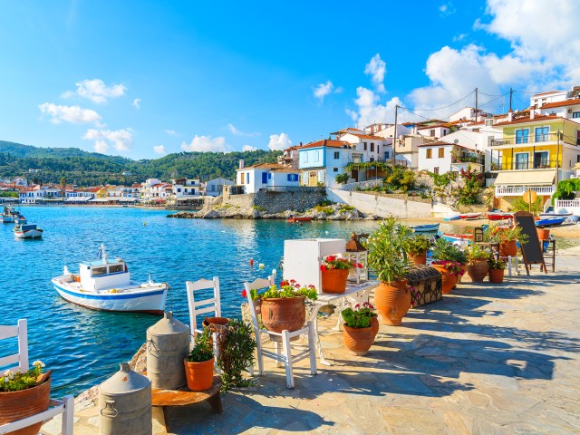 Dining tables along water in Samos, Greece