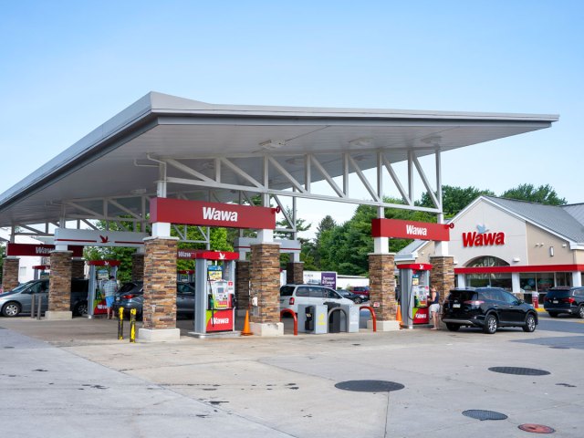 Gas station pumps and exterior of Wawa convenience store