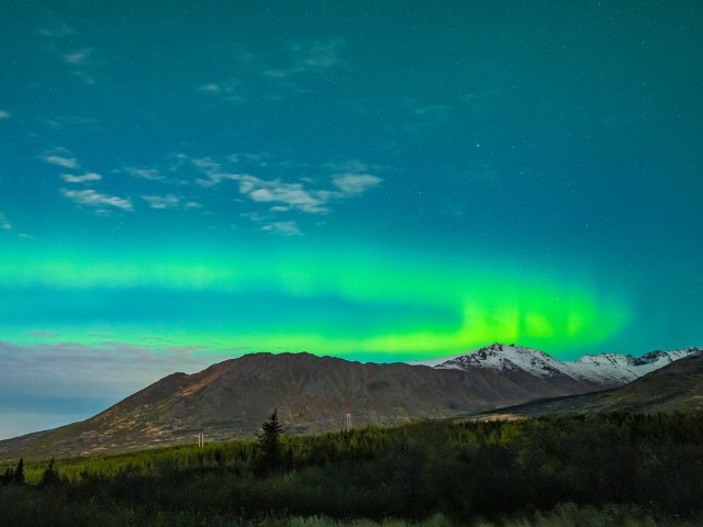 Green aurora over mountains outside of Anchorage, Alaska