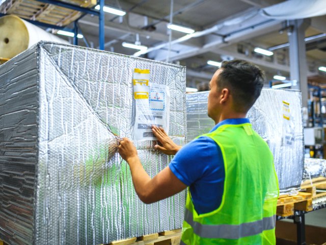Airport employee packaging freight